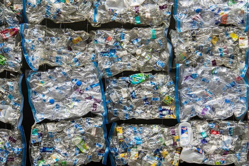 Bales of post‑consumer rPET bottle flakes PCR recycled plastic feedstock for extrusion processing